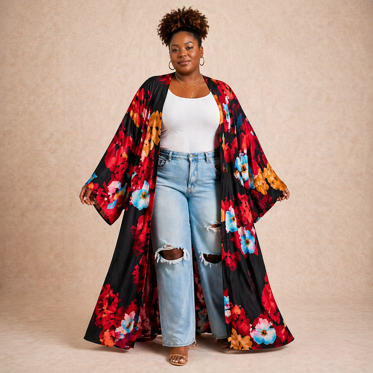 Woman wearing a colorful floral kimono over a white top and jeans on a beige background