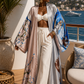 Woman in a stylish outfit on a balcony with ocean view (Pink)