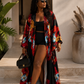Woman wearing a colorful floral kimono over a black outfit, standing on steps with plants and a pot in the background.