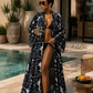 Woman in a black and white patterned robe by a poolside