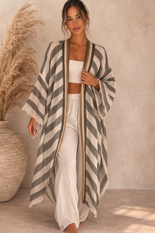 Woman wearing a long, striped kimono-style garment indoors.(Grey)