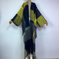 Colorful patterned coat with fringes on a mannequin against a white background (Blue)