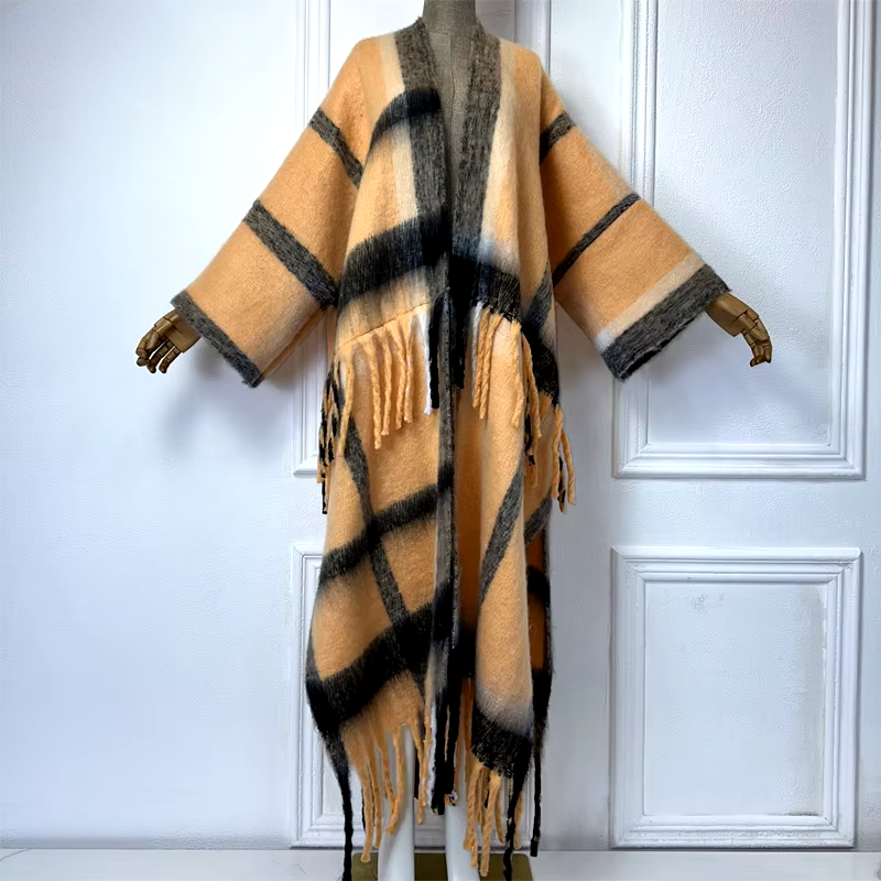 A wool kimono cardigan with a geometric pattern in beige, black, and white colors, displayed on a mannequin. (Orange)
