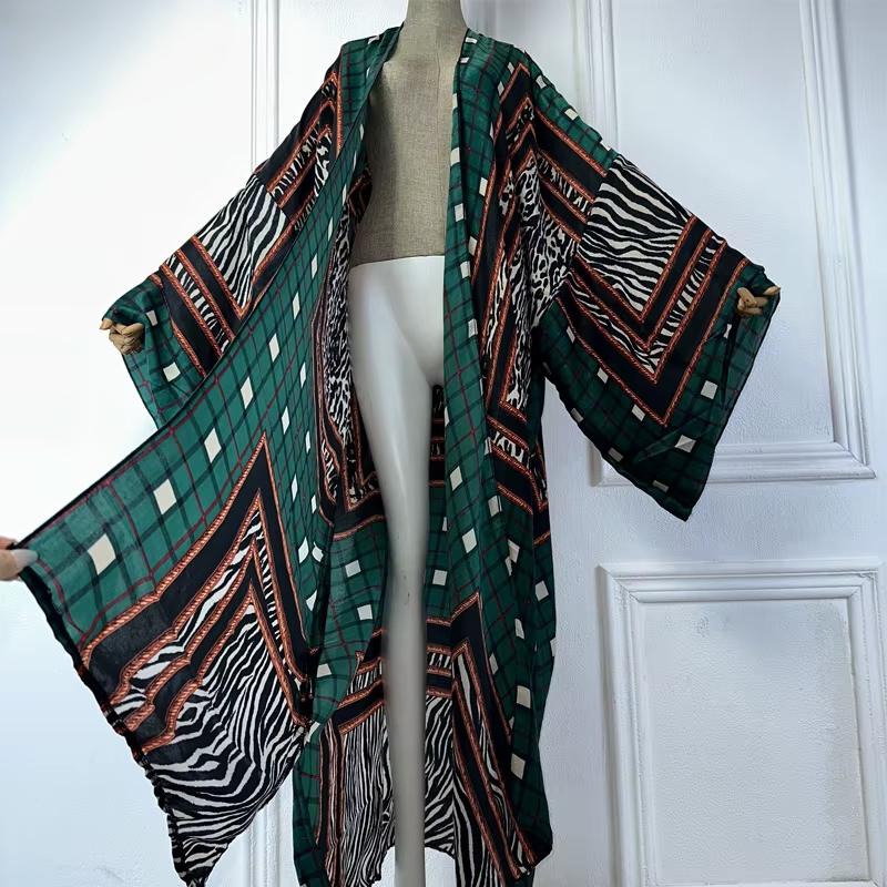 Mannequin wearing a green patterned kimono against a white  paneled wall. (Green)