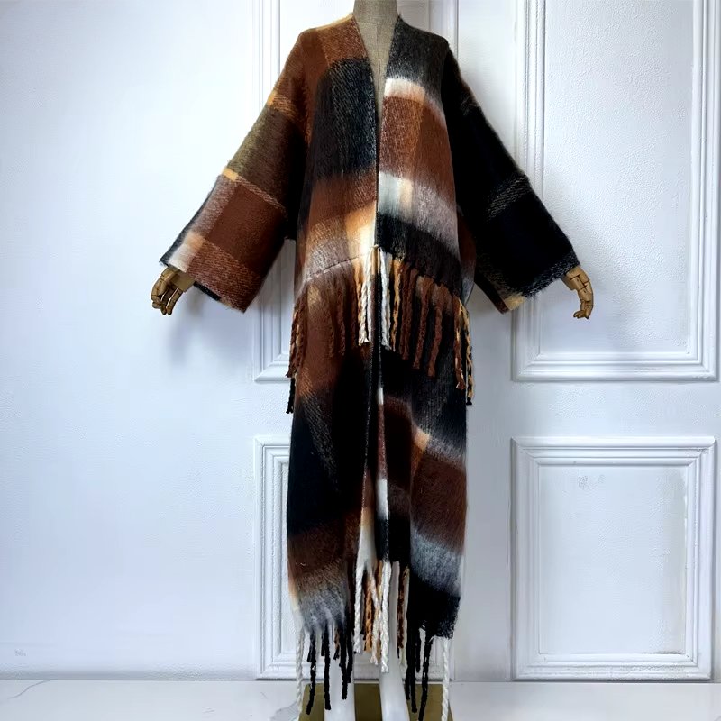 A wool kimono cardigan with a geometric pattern in beige, black, and white colors, displayed on a mannequin. (Brown)