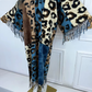 Leopard print scarf with denim accents draped over a mannequin against a white wall. (Blue)