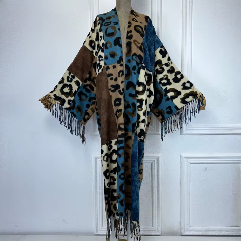 Leopard print scarf with fringes draped over a mannequin against a white paneled wall. (Blue)
