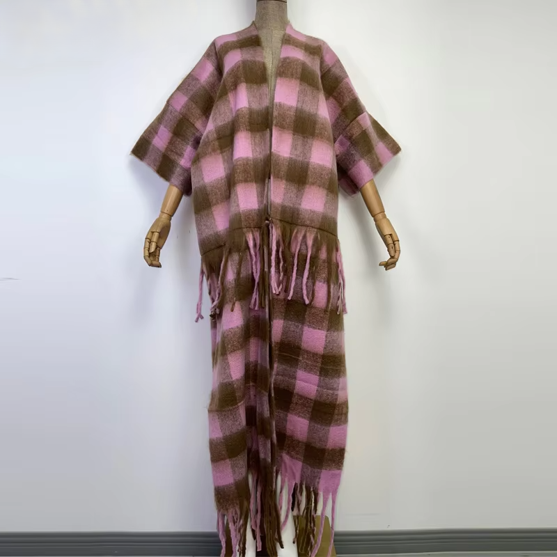 A black and beige checkered wool kimono with fringes displayed on a mannequin. (Pink)