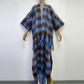 A black and beige checkered wool kimono with fringes displayed on a mannequin. (Blue)