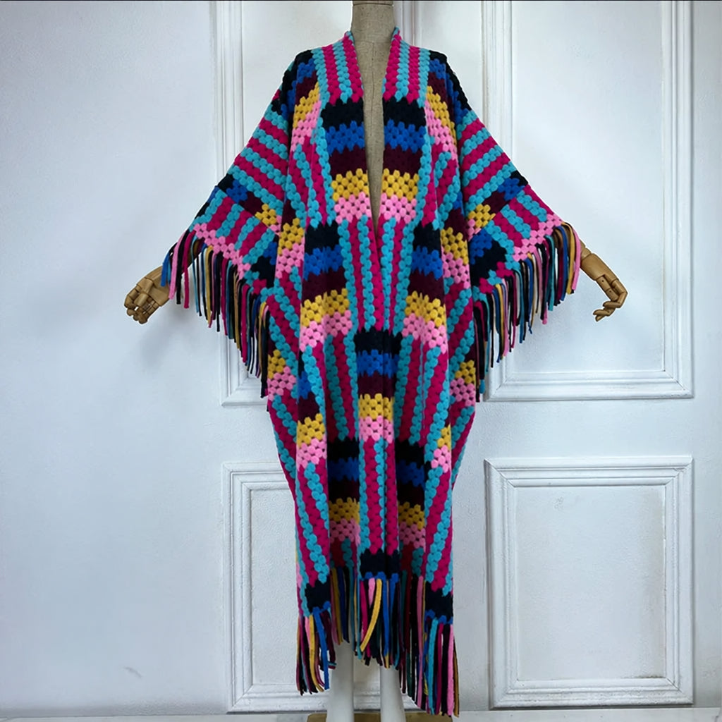 Colorful crocheted poncho on a mannequin against a white background  (Pink)