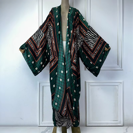 Mannequin wearing a patterned kimono against a white paneled wall. (Green)