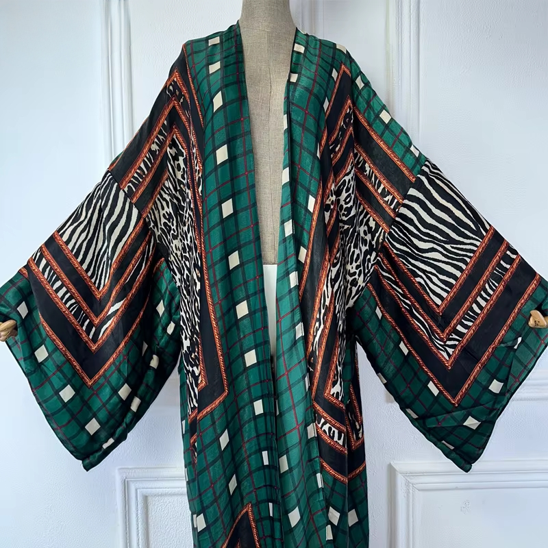 Colorful patterned kimono draped over a mannequin against a white wall. (Green)