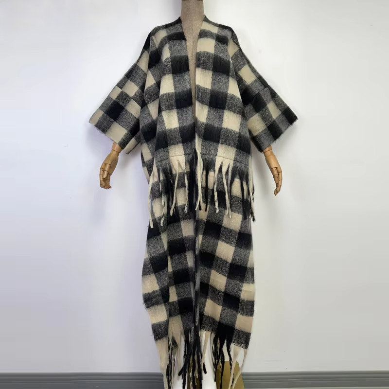 A black and beige checkered wool kimono with fringes displayed on a mannequin. (Black)