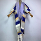 A wool kimono with a colorful striped pattern and tassel detailing displayed on a mannequin. (Purple)