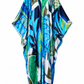 A lightweight, open-front kaftan or poncho with a vibrant tropical leaf print in shades of blue, green, navy, and white, displayed against a solid white background.